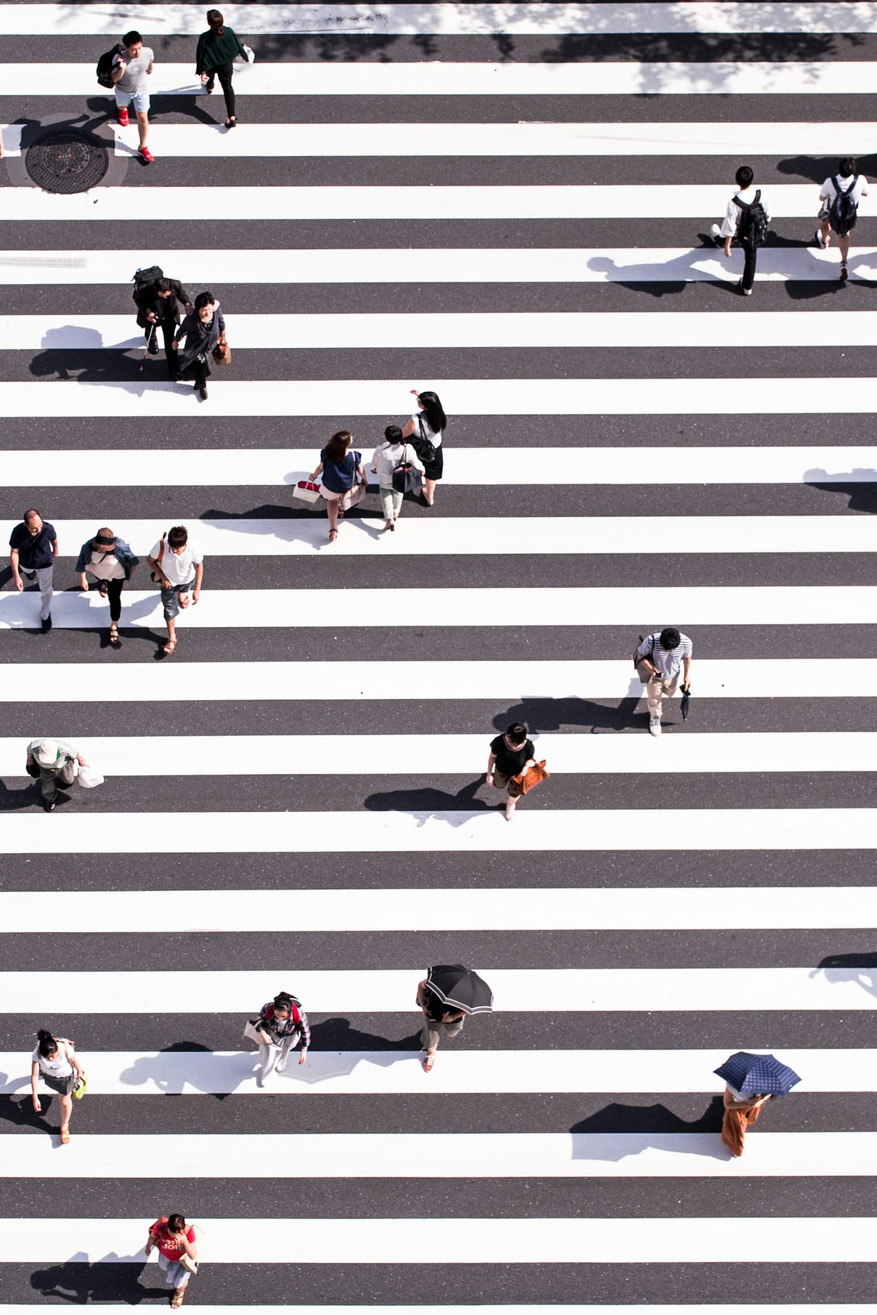 Aerial view of a busy crosswalk with many people, representing teams across Canada
